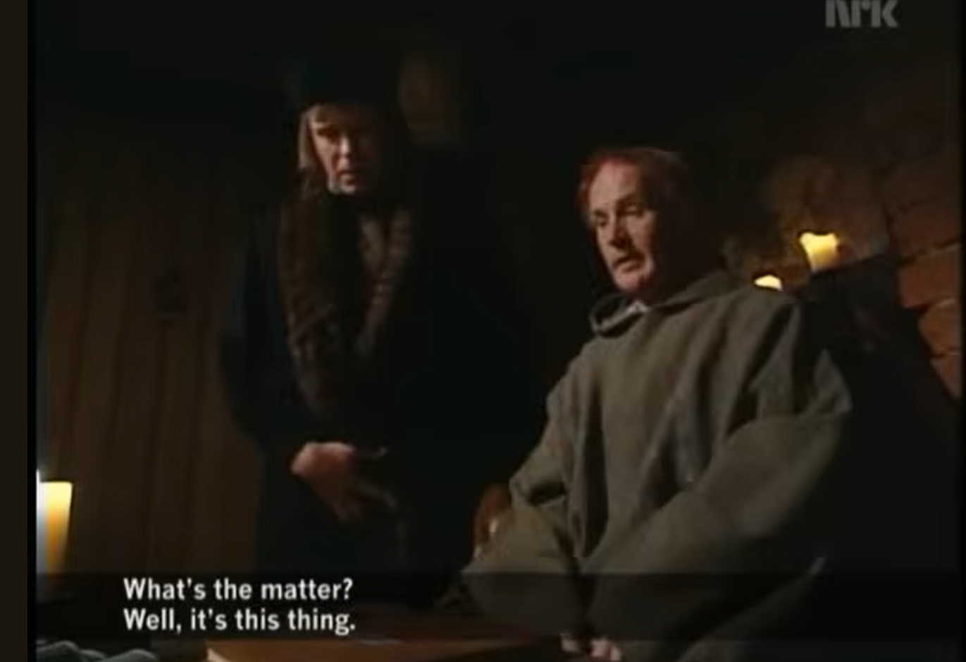 Still from https://www.youtube.com/watch?v=pQHX-SjgQvQ originally produced in Norway by NRK in 2001. The scene is a monk being visited by another man, with a closed book on his desk.